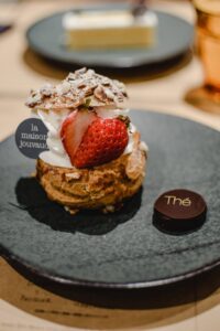 Enjoy this indulgent strawberry pastry adorned with cream and almonds in a Kyoto café.