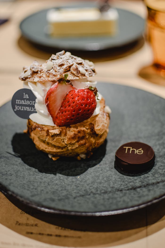 Enjoy this indulgent strawberry pastry adorned with cream and almonds in a Kyoto café.